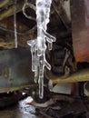 Ice cycles hanging from rusted truck