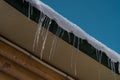 Ice dams on house roof. Heavy snow stacked on the roof Royalty Free Stock Photo