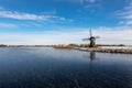 Ice on the Dieperpoel Kagerplassen in front of a windmill de Kok and house on the Kogjespolder Royalty Free Stock Photo