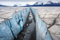 ice-filled glacier cracks contrasting surrounding unsettled soil