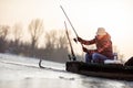 Ice fishing on frozen lake- fisherman catch fish