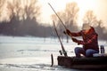 Ice fishing on frozen lake- smiling fisherman catch fish Royalty Free Stock Photo