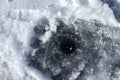 Ice fishing hole in frozen lake Royalty Free Stock Photo