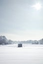 Ice fishing shacks at a Minnesota lake on a bright winter morning