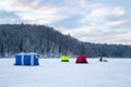 Ice fishing tent on a frozen lake at sunset. Fisherman camp on a peaceful winter evening Royalty Free Stock Photo
