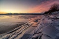 Ice floes on the lake shore. Colorful sky during sunrise on cold winter morning.Dam Liptovska Mara, Slovakia Royalty Free Stock Photo