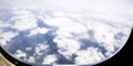 Ice flowers on airplane window, with mountains and clouds in background Royalty Free Stock Photo