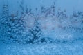 Ice flowers. Window frost. Winter time background. Frozen icy texture