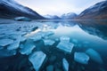 ice fragments floating in dark blue glacial lake Royalty Free Stock Photo