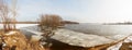 Ice fragments under thin layer of frozen river water.