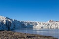 Ice front of Esmarkbreen glacier in Spitsbergen, sea, blue sky