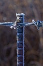 Frost on a metal fencepost