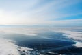 Ice of frozen dark-blue transparent waters of mountain lake