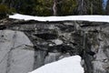 An ice frozen wall of grant with melting water