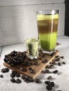 Ice Green Tea Coffee background with coffee beans in wood bowl Royalty Free Stock Photo