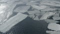 The ice has broken on the river. Ice floes of different sizes float in the water. Lumps of ice.