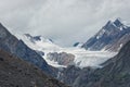 Ice high in the mountains. Aktru glaciers in the Altai mountains clear ice among rocks and mountain peaks