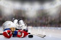 Ice Hockey Helmet, Skates, Gloves, Stick and Puck in Rink