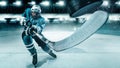 Ice Hockey player athlete in the helmet and gloves on stadium with stick. Action shot. Sport concept.