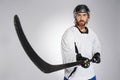 Ice hockey player in helmet pointing black stick into camera. Royalty Free Stock Photo