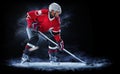 Ice hockey player isolated on black background