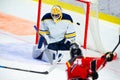 Ice hockey player shoots a slap shot to score a goal