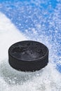 An ice hockey puck at the blue line Royalty Free Stock Photo