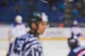 Ice hockey referee over the plexi glass - championship professional game editorial photo Royalty Free Stock Photo