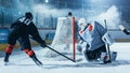 Ice Hockey Rink Arena: Goalie Against Forward Player who is Doing Slapshot, Shots Puck with Stick Royalty Free Stock Photo