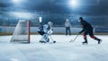 Ice Hockey Rink Arena: Goalie is Ready to Defend Score against Forward Player who Shoots Puck with Royalty Free Stock Photo