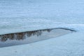 An ice hole in a frozen pond begins to melt. Trees and sky are reflected in the water. Royalty Free Stock Photo