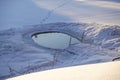 Ice hole in the lake in winter is equipped with a ladder for launching Royalty Free Stock Photo
