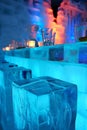 Ice hotel bar interior with clear ice stools and illuminated shelves Royalty Free Stock Photo
