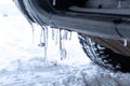 Ice icicles formed on a car in winter