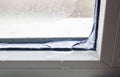 Ice inside in the corner of a window in winter. Poor warm isolat Royalty Free Stock Photo
