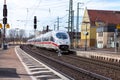 ICE 3, intercity-Express train from Deutsche Bahn passes train station Royalty Free Stock Photo