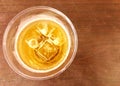 Ice lager beer with ice and foam in frosty transparent glass on wooden table background. Royalty Free Stock Photo