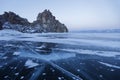 Ice on Lake Baikal. Shamanka rock. Evening landscape Royalty Free Stock Photo