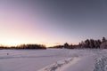 The ice lake and forest has covered with heavy snow and nice blue sky in winter season at Holiday Village Kuukiuru, Finland Royalty Free Stock Photo