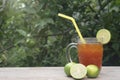 Ice lemon tea in a clear glass. Garnish with a slice of lemon on the glass corner. Royalty Free Stock Photo