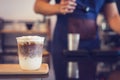 Ice Macchiato coffee cup on the wood plate at coffee shop. Barista background Royalty Free Stock Photo