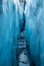 Blue ice of the walls of a large water-filled crevasse Royalty Free Stock Photo