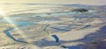 Ice melts on the lake in early spring. Reflection of a clear blue sky