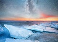 Ice on the ocean shore at the night time. Sea bay and stars at the night time. Milky way above ocean, Norway.