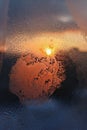 Ice patterns, water drops and sunlight on a winter window glasss Royalty Free Stock Photo