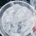 Ice in a plastic cup sitting in car cupholder