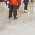 Ice rink. Abstract boy on skates back to us learning to skate outdoors in skating rink. Winter outdoor activities, sport Royalty Free Stock Photo