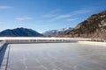 ice rink on frozen river with view of distant mountain range Royalty Free Stock Photo