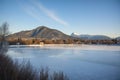 ice rink on frozen river with view of distant mountain range Royalty Free Stock Photo