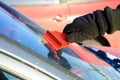 Ice scraping - removing ice and snow from car Royalty Free Stock Photo